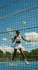 Female Tennis Player in Action at Sunny Outdoor Court