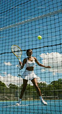 Female Tennis Player in Action at Sunny Outdoor Court