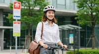 Smiling Woman Commuting on Bicycle in Urban Setting