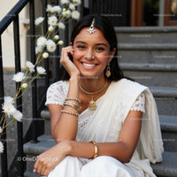 Smiling Woman in Elegant White Sari with Daisies