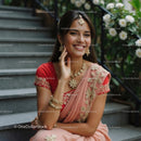 Smiling Woman in Elegant Pink and Red Saree with Floral Details