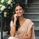 Smiling Woman in Elegant Saree with Floral Background