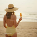 Woman in Yellow Swimsuit Enjoying Popsicle on Beach