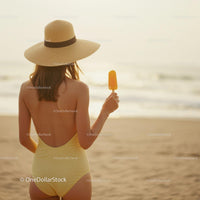 Woman in Yellow Swimsuit Enjoying Popsicle on Beach