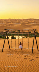 Child on Swing Overlooking Tranquil Desert Oasis