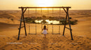Girl on Swing Overlooking Desert Oasis at Sunset
