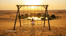 Girl on Swing Overlooking Desert Oasis at Sunset