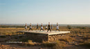 Group Yoga Practice on Elevated Outdoor Platform in Desert