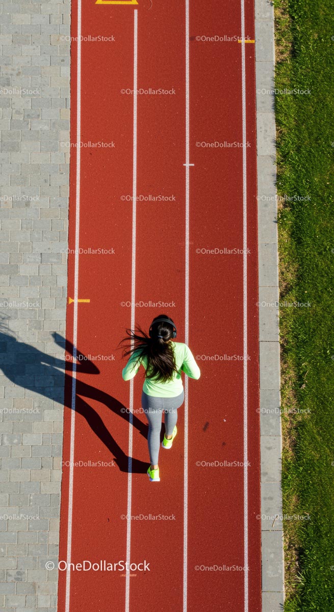 Aerial View of Woman Jogging on Red Running Track