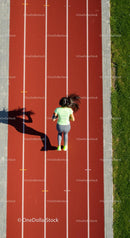 Woman Running on Red Track at Outdoor Stadium