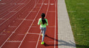 Woman Jogging on Outdoor Running Track in Neon Athletic Wear