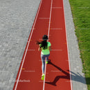Woman Jogging on a Red Running Track in Sunny Weather