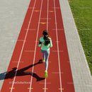 Woman Running on Red Athletic Track in Green Sportswear