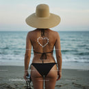 Woman in Straw Hat Enjoying Ocean View at the Beach