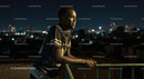 Thoughtful Young Man Overlooking Urban Night Skyline
