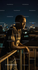 Thoughtful Young Man Gazing at Night Cityscape