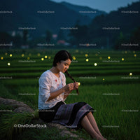 Peaceful Evening in Rice Fields with Woman Braiding Hair