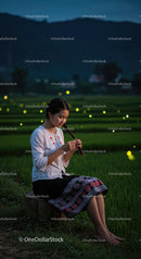 Woman in Traditional Clothing in Tranquil Rice Field at Dusk