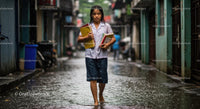Determined Student Walking in Rain with Books
