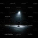 Solitary Figure Under Street Lamp in Dark Parking Lot