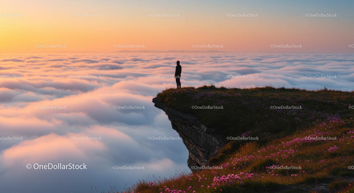 Silhouette on Mountain Overlooking a Cloudy Sunset
