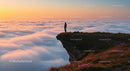 Silhouette on Mountain Overlooking a Cloudy Sunset
