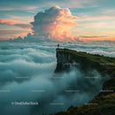 Hiker Standing on a Mountain Cliff Above a Sea of Clouds