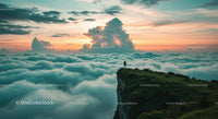 Traveler on Cliff Overlooking Clouds at Sunset