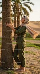 Smiling Woman in Hijab by Palm Tree in Desert Landscape