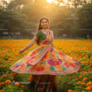 Woman in Colorful Sari Twirling in Marigold Field