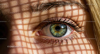 Close-up of a Green Eye with Sunlit Shadow Patterns