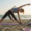 Women Practicing Yoga on a Beach at Sunset