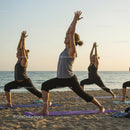Women Practicing Yoga at Sunset on Scenic Beach
