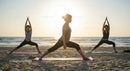 Women Practicing Yoga at Sunset on a Tranquil Beach