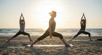 Women Practicing Yoga at Sunset on a Tranquil Beach