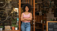 Friendly Small Business Owner in Bicycle Shop Entrance