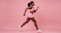 Athletic Woman Jogging Against a Pink Background