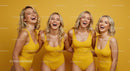 Group of Laughing Women in Yellow Swimsuits