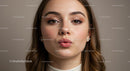 Glamorous Young Woman Blowing a Kiss