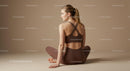 Woman Meditating in Brown Outfit on Yoga Mat