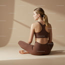 Woman Meditating in Brown Activewear on Beige Background