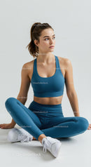 Young Woman in Blue Activewear Sitting in Relaxed Pose