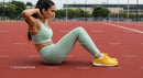 Athletic Woman Performing Sit-Ups on Running Track
