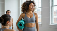 Women Smiling with Yoga Mat in Bright Fitness Studio