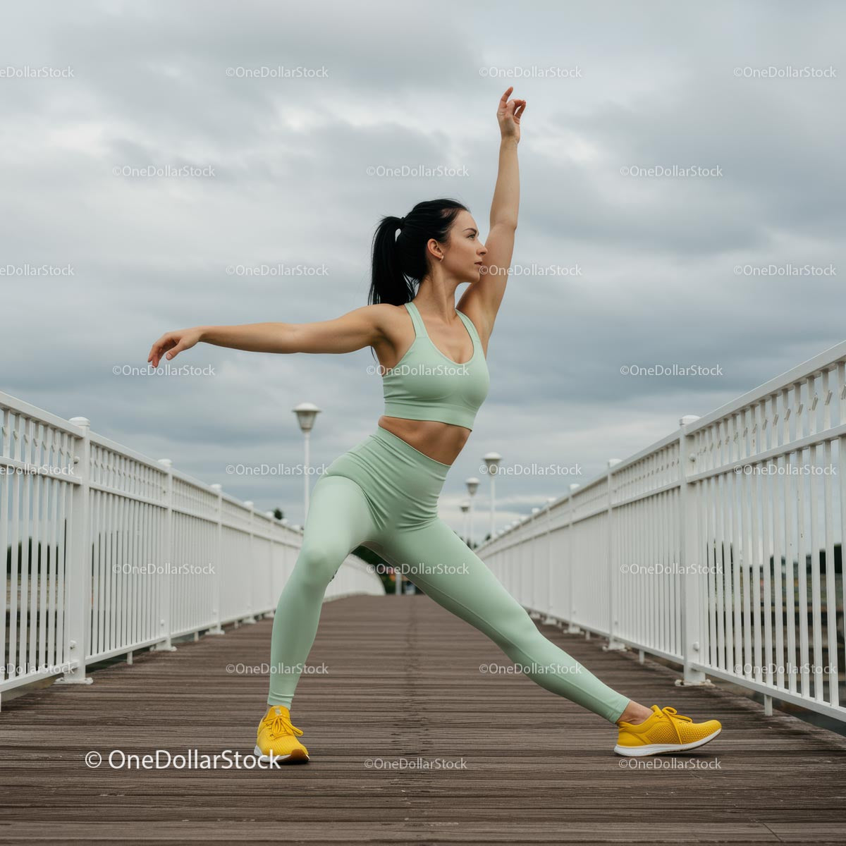 Athletic Woman Practicing Yoga on a Bridge