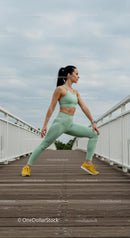 Woman Stretching on Bridge in Mint Green Activewear