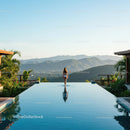 Woman by an Infinity Pool with Mountain Views in Tropical Paradise