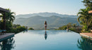 Woman Relaxing in Infinity Pool with Mountain View