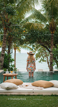 Woman in Floral Dress by Pool Overlooking Tropical Ocean