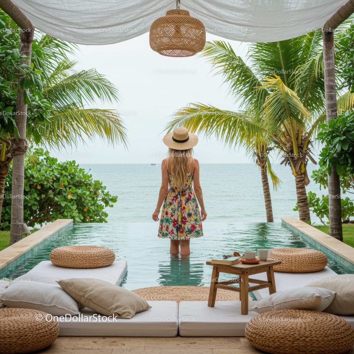 Woman in Floral Dress Standing by an Infinity Pool